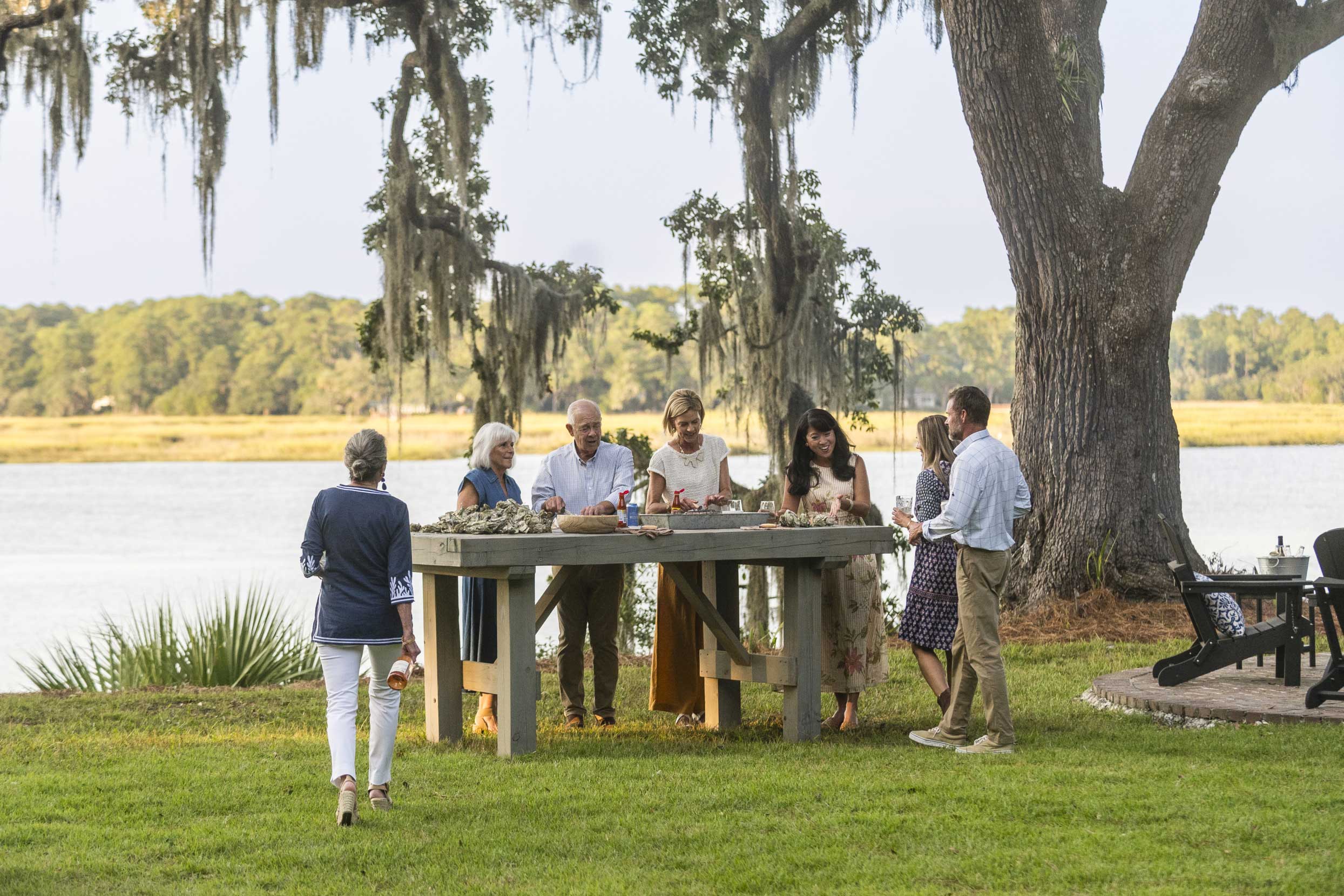 People gathering around a table at Montage Palmetto Bluff